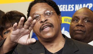 In this photo taken April 28, 2014, Leon Jenkins, president of the Los Angeles chapter of the NAACP, announces that Los Angeles Clippers basketball team owner Donald Sterling will not be receiving his lifetime achievement award, at a news conference in Culver City, Calif. Jenkins has his own legal problems, which are coming into focus now that the NBA has banned Sterling for racist comments. (AP Photo/Nick Ut)
