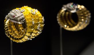 &amp;quot;Snake&amp;quot; bracelet-watch in yellow gold and enamel, with rubies and diamonds is exhibited at the Bulgari: 130 Years of Masterpieces exhibition in the Houston Museum of Natural Science on April 29, 2014 in Houston.  Richard Burton once quipped that Elizabeth Taylor knew only one Italian word: Bulgari.  Taylor collected hundreds of fabulous jewels in her lifetime, but few as grand as the Bulgari pieces from Burton, including a platinum-and-diamond necklace centered around a 65-carat Burmese cabochon sapphire, a present for her 40th birthday.    The necklace is one of 150 one-of-a-kind creations from the Bulgari Heritage collection on display beginning Friday at the Houston Museum of Natural Science in &amp;quot;Bulgari: 130 Years of Masterpieces.&amp;quot; A section of the exhibit is devoted to Taylor&#39;s famous pieces from the Italian jeweler.  (AP Photo/Houston Chronicle, Marie D. De Jesus) MANDATORY CREDIT