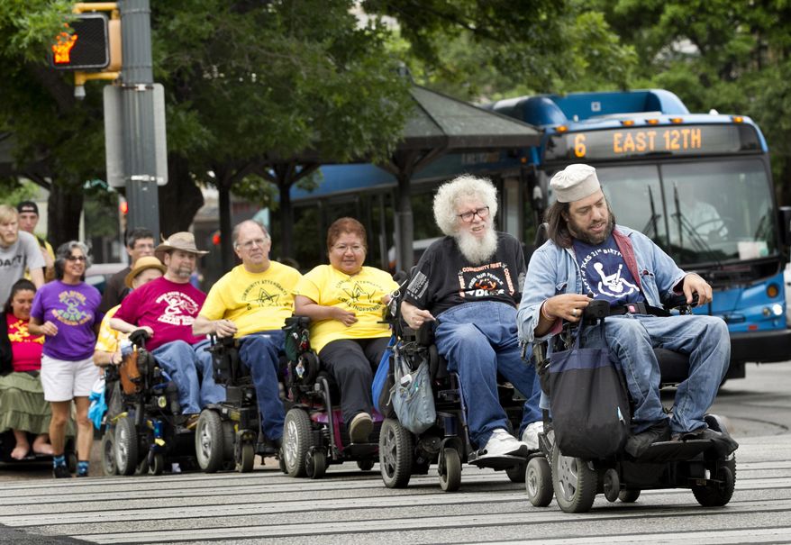 Members of From front to back, Heiwa Salovitz, Bob Kafka, Renee Lopez, Mark Cundall and Gene Rodgers, members of the advocacy group ADAPT of Texas, cross the street, as they make their way to the Capitol on April 24, 2014 in Austin. The group hopes to encourage legislators to improve accessibility for disabled people. (AP Photo/Austin American-Statesman, Laura Skelding) AUSTIN CHRONICLE OUT, COMMUNITY IMPACT OUT, INTERNET AND TV MUST CREDIT PHOTOGRAPHER AND STATESMAN.COM, MAGS OUT