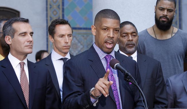 In this photo taken on April 29, 2014, Sacramento, Calif., Mayor Kevin Johnson, at podium, with Los Angeles Mayor Eric Garcetti, left, speaks about the penalties imposed on Los Angeles Clippers owner Donald Sterling by the NBA at a news conference at Los Angeles City Hall. From second left are current and former NBA players Steve Nash, Norm Nixon and Tyson Chandler. Last year Johnson almost single-handedly kept the Kings NBA franchise in Sacramento, staging a late-game comeback to snatch the team away from a Seattle billionaire. This spring he began raising his national political profile by taking over as the head of the U.S. Conference of Mayors, then acting as spokesman for the NBA players as the controversy over racist remarks by the Clippers&#x27; owner threatened to throw the basketball league into turmoil. (AP Photo/Nick Ut)