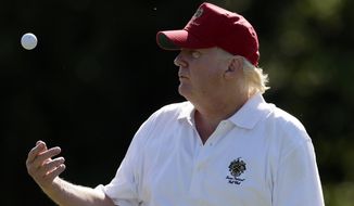 Donald Trump tosses a ball while standing on the 14th fairway during a pro-am round of the AT&amp;T National golf tournament at Congressional Country Club, Wednesday, June 27, 2012, in Bethesda, Md. (AP Photo/Patrick Semansky)