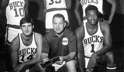 **FILE** Milwaukee Bucks coach Larry Costello is surrounded by players Bob Dandridge (10), Lew Alcindor (33), Greg Smith, top right, Jon McClocklin (14) and Oscar Robertson (1). (AP Photo)