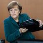 German Chancellor Angela Merkel arrives at the weekly cabinet meeting in Berlin, Germany, Wednesday, April 30, 2014. (AP Photo/Markus Schreiber)