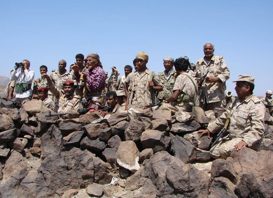 In this handout photo provided by Yemen&#39;s Defense Ministry, Yemeni troops take position during the fight against al-Qaida militants in the southern province of Shabwa, Yemen, Wednesday, April 30, 2014. Yemeni military on Tuesday, April 29, launched a major offensive targeting al-Qaida hideouts and strongholds, killing at least eight suspected militants, security officials said. (AP Photo/Yemen Defense Ministry)