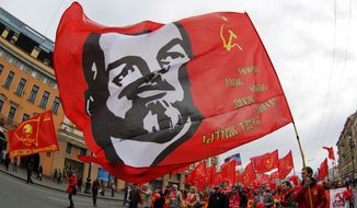 Communists carry a flag depicting Vladimir Lenin, the Soviet Union founder, during a traditional May Day march in St. Petersburg, Russia, Thursday, May 1, 2014. (AP Photo/Dmitry Lovetsky) ** FILE **