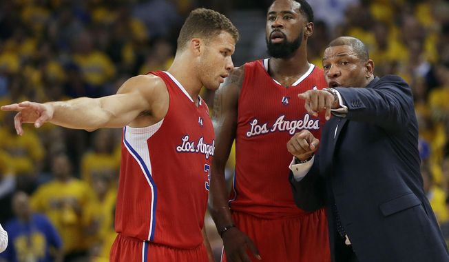 Los Angeles Clippers head coach Doc Rivers, right, gestures as he talks with forward Blake Griffin, left, and center DeAndre Jordan during the first half of Game 6 of an opening-round NBA basketball playoff series against the Golden State Warriors in Oakland, Calif., Thursday, May 1, 2014. (AP Photo/Marcio Jose Sanchez)