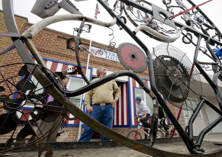 ADVANCED FOR RELEASE SATURDAY, MAY 3, 2014 A large metal-sculpted garden gate, created by school children, sits on a trailer in front of the New Plymouth Veterans Hall where it was auctioned to benefit the Robert Manwill Scholarship Fund Friday April 25, 2014. A scholarship fund was created a year after child abuse victim Robert Manwill was found dead nearly five years ago in Boise. His classmates in New Plymouth will benefit from the fund when they graduate high school in 2017. Those same students and others in the community helped create a metal sculpture under the direction of artist Pattie Young and sold for $600 to Zions Bank Branch Manager Julia Harrison. Harrison said the gate will be donated to one of the New Plymouth School District schools. (AP Photo/Idaho Statesman, Darin Oswald)
