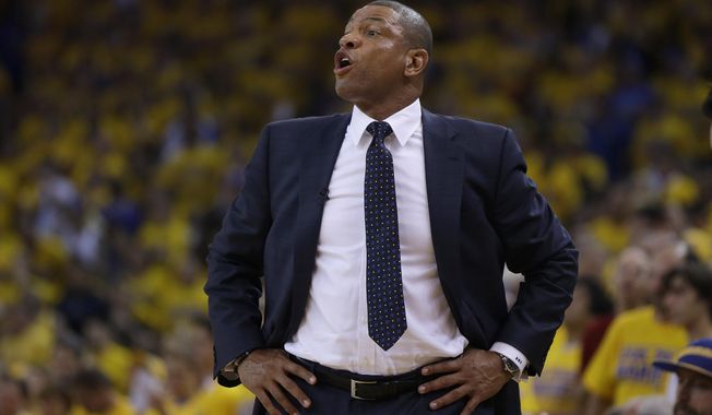 Los Angeles Clippers head coach Doc Rivers talks to his team from the sideline during the first quarter of Game 6 of an opening-round NBA basketball playoff series against the Golden State Warriors in Oakland, Calif., Thursday, May 1, 2014. (AP Photo/Marcio Jose Sanchez)