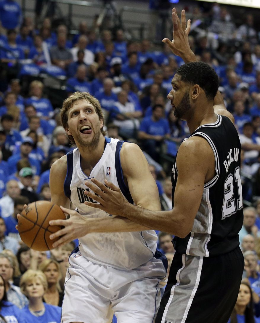 Dallas Mavericks&#39; Dirk Nowitzki (41), of Germany, looks for a shooting opportunity against San Antonio Spurs&#39; Tim Duncan (21) in the first half of Game 6 of an NBA basketball first-round playoff series on Friday, May 2, 2014, in Dallas. (AP Photo/Tony Gutierrez)
