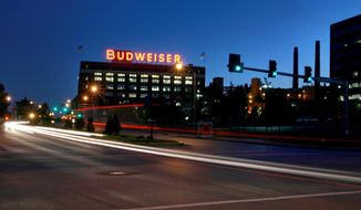 In this July 13, 2008 photo cars move near the Anheuser-Busch St. Louis brewery. August Busch III was CEO of Anheuser-Busch Companies for nearly three decades before his 2002 retirement, remaining as board chairman until 2006. The St. Louis brewer is being sued for gender discrimination by Francine Katz, who was the company’s highest ranking female executive before her 2008 resignation. Katz says she was grossly underpaid compared to her male predecessor and other top male executives at the company. (AP Photo/St. Louis Post-Dispatch, David Carson)