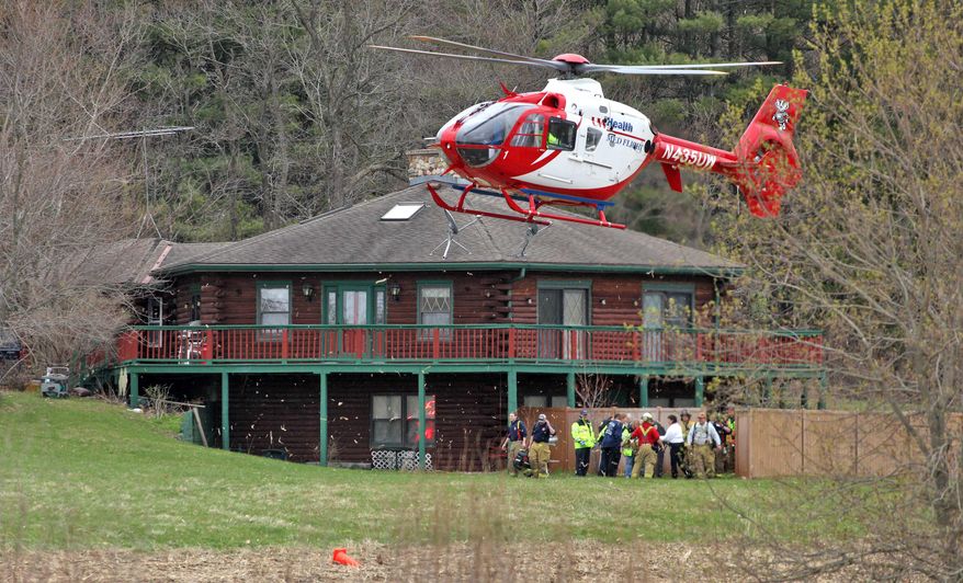 A second medical helicopter takes off from the scene where two Dane County sheriff's deputies were both stabbed in the leg during an response to a disturbance in the town of Primrose, north of New Glarus, Wis., Thursday, May 1, 2014. An unnamed third deputy fatally shot the man who stabbed Lt. Brian Hayes and Deputy Roger Finch. The two stabbed deputies were airlifted to UW Hospital with non life-threatening injuries. (AP Photo/The Monroe Times, Anthony Wahl)