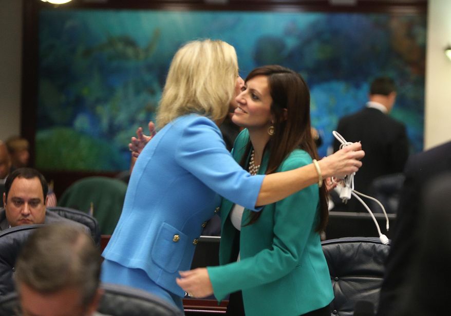 Rep. Rep. Jeanette M. Nunez, R- Miami, right,  sponsor of the House immigrant tuition bill gets a hug from Rep. Heather Dawes Fitzenhagen, R- Fort Myers, left,  Friday, May 2, 2104 after the bill passed the Florida House.  (AP Photo/The Tampa Bay Times, Scott Keeler)