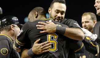Pittsburgh Pirates&#39; Starling Marte (6) gets a hug from Pedro Alvarez, right, after Marte hit the game-winning home run in the bottom of the ninth inning of the baseball game against the Toronto Blue Jays on Friday, May 2, 2014, in Pittsburgh. Alvarez had hit a two-run homer earlier in the inning to tie the game. The Pirates won 6-5. (AP Photo/Keith Srakocic)