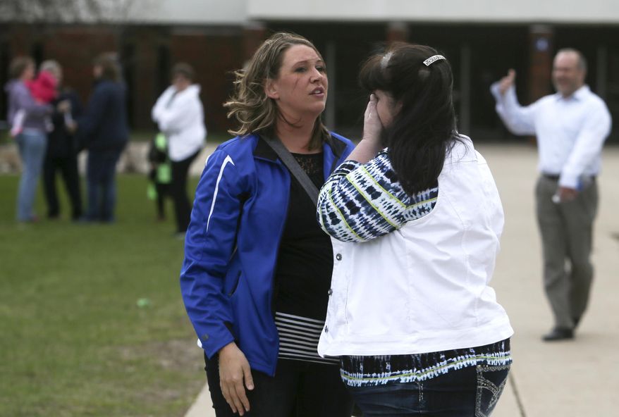 A parent consoles another parent after a meeting in Waseca High School, on Friday, May, 2, 2014, in Waseca, Minn. A plot by a 17 year-old Waseca High student to kill his family and to massacre students in Waseca was uncovered and foiled on Thursday. (AP Photo/The Star Tribune, David Joles) MANDATORY CREDIT; ST. PAUL PIONEER PRESS OUT; MAGS OUT; TWIN CITIES TV OUT