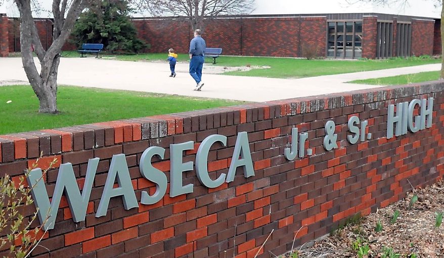 A family walks in to the Waseca Junior and Senior High School to attend a community meeting addressing safety concerns, Friday, May 2, 2014, in Waseca, Minn. Police stopped a 17-year-old Waseca boy's attempt to place bombs in the school earlier this week. (AP Photo/Mankato Free Press, Pat Christman)