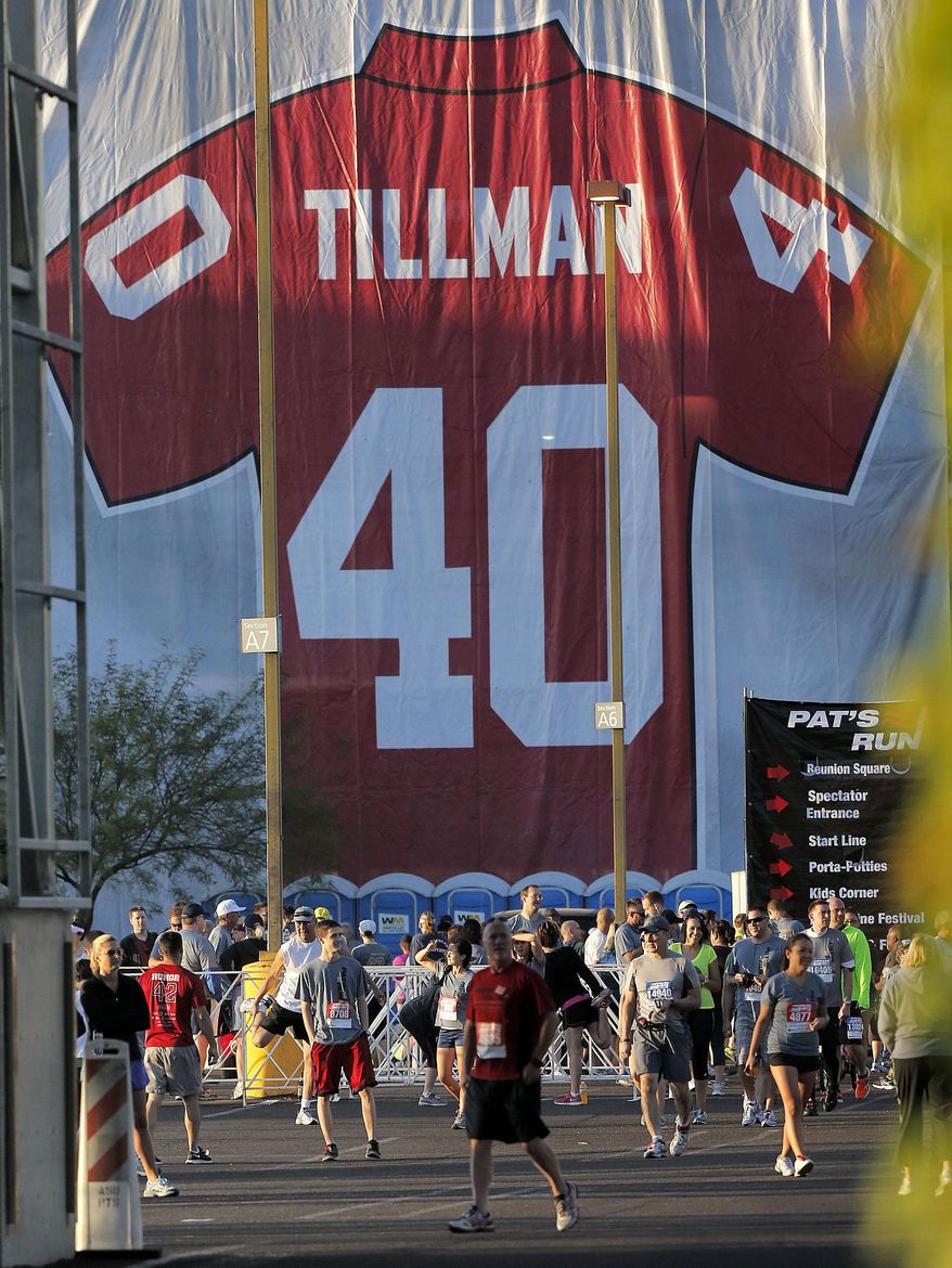 ADVANCE FOR WEEKEND EDITIONS, MAY 3-4 - FILE - In this April 20, 2013, file photo, runners prepare for the 9th annual Pat's Run in Tempe, Ariz. Pat's Run is filled with inspirational stories all wanting to honor the memory of NFL star-turned-soldier Pat Tillman. For seven years, Sheldon Davidson had become the annual exclamation point to the run, climbing out of his wheelchair and dragging the paralyzed left side of his body across the final 42 yards. He died 42 days before this year's run, so his wife and daughter made the journey without him, honoring two heroes with every step. (AP Photo/Matt York, File)
