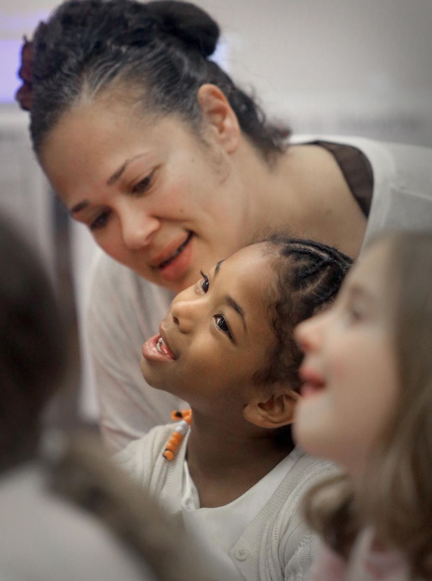 Elise Butterfield interacts with her daughter, LaShya Washington, 6, during a visit to the girl's first grade class at Mendota Elementary School in Madison, Wis. Friday, March 28, 2014. The Madison School District is opening its schools to students' parents as a way to engage families. (AP Photo/Wisconsin State Journal, John Hart)