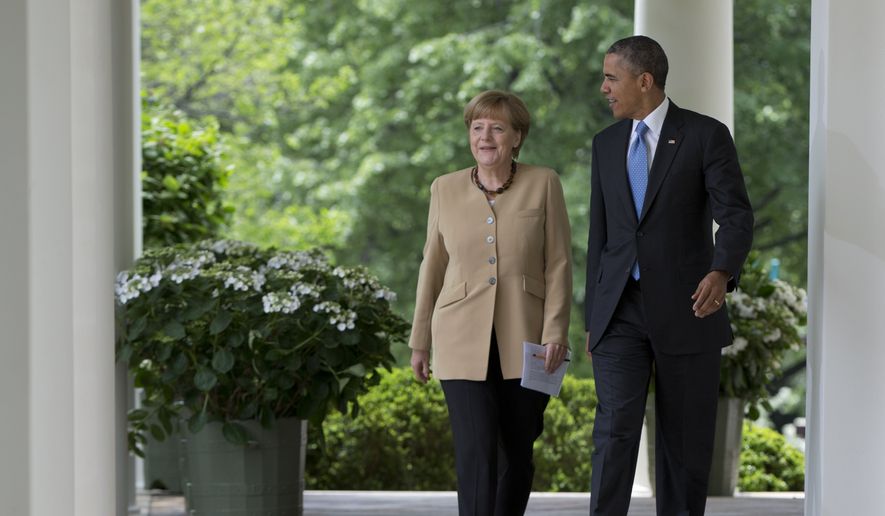President Barack Obama and German Chancellor Angela Merkel walk from the Oval Office of the White House in Washington, Friday, May 2, 2014, to their joint news conference in the Rose Garden. Obama and Merkel are putting on a display of trans-Atlantic unity against an assertive Russia, even as sanctions imposed by Western allies seem to be doing little to change Russian President Vladimir Putin&#39;s reasoning on Ukraine. (AP Photo/Carolyn Kaster)
