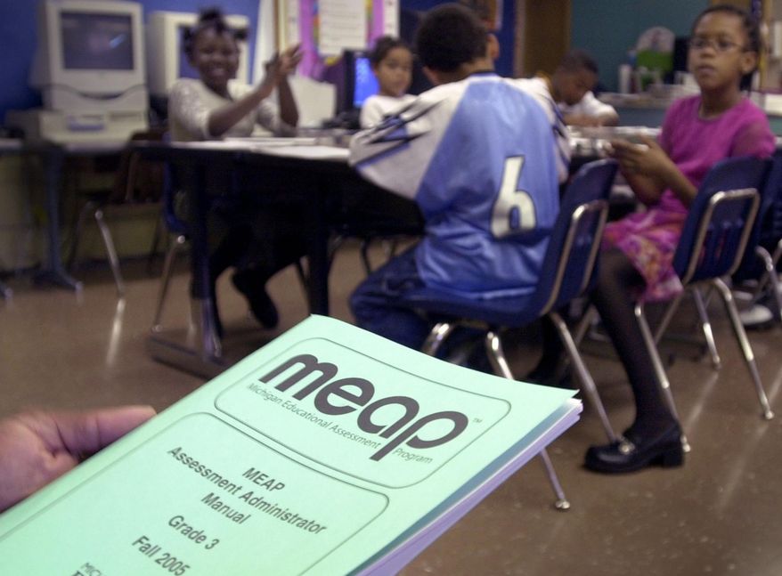ADVANCE FOR SUNDAY, MAY 4 - FILE- In an Oct. 4, 2005 file photo, a teacher at Charles F. Brunkow Elementary School in Buena Vista Township, Mich., uses a Michigan Educational Assessment Program manual to prepare his class to start taking the test. Lawmakers are balking at plans to give Common Core-based exams to Michigan kids next year, pushing for a pause of the test that’s expected to replace the MEAP, an assessment that the state has used for nearly 45 years. (AP Photo/The Saginaw News, Jeff Schrier)