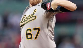Oakland Athletics starting pitcher Dan Straily delivers to the Boston Red Sox during the first inning of a baseball game at Fenway Park in Boston, Friday, May 2, 2014. (AP Photo/Charles Krupa)