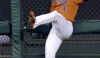 Houston Astros right fielder George Springer (4) misses the catch against the bullpen fence, giving Seattle Mariners&#39; Kyle Seager a two-run double, in the sixth inning of a baseball game on Friday, May 2, 2014, in Houston. (AP Photo/Pat Sullivan)