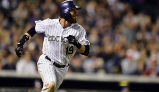 Colorado Rockies&#39; Charlie Blackmon watches the flight of a solo home run against the New York Mets during the seventh inning of a baseball game, Friday, May 2, 2014, in Denver. (AP Photo/Jack Dempsey)