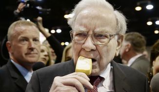 Berkshire Hathaway Chairman and CEO Warren Buffett eats an ice cream bar while touring the exhibition floor prior to the annual shareholders meeting on Saturday, May 3, 2014, in Omaha, Neb. More than 30,000 shareholders are expected to fill the CenturyLink Arena to hear Buffett and Berkshire Vice Chairman Charlie Munger discuss their business. (AP Photo/Nati Harnik)