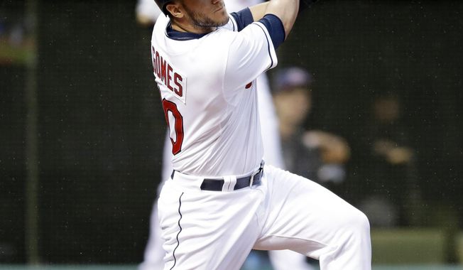 Cleveland Indians&#x27; Yan Gomes hits a two-RBI double off Chicago White Sox starting pitcher John Danks in the first inning of a baseball game on Friday, May 2, 2014, in Cleveland. Indians&#x27; Michael Brantley and Ryan Raburn scored on the hit. (AP Photo/Tony Dejak)