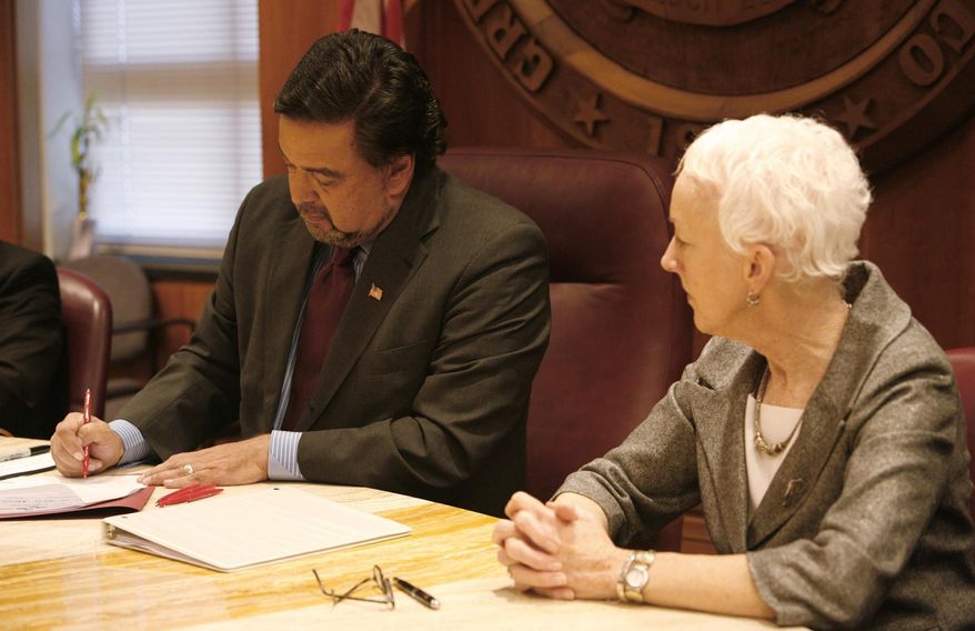 FILE - In this March 18, 2009, file photo, former New Mexico Gov. Bill Richardson signs the repeal of the death penalty in his office in Santa Fe, N.M., while Rep. Gail Chasey, D-Albuquerque, looks on. Richardson has since campaigned against the death penalty in other states. He described meeting with several exonerated death row inmates. There are more than 140 nationwide, as well as families of victims and law enforcement officials.  (AP Photo/Jane Phillips, The New Mexican, File)