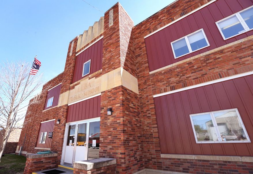 This May 1, 2014 photo shows Elba Public School in Elba, Neb. Elba Public School has an average daily enrollment of 25 or fewer students in ninth through 12th grades. Next year, it is on track to stay that way. Because of a state law, however, that means the school might be forced to close its doors. Superintendent Mikal Shalikow and the school board are searching for options, from bringing in students to unifying or even consolidating with another school. But while Elba's issue is a question of how to keep its school open, as in many small towns, it is also a question of whether the community will survive. (AP Photo/The Independent, Barrett Stinson)
