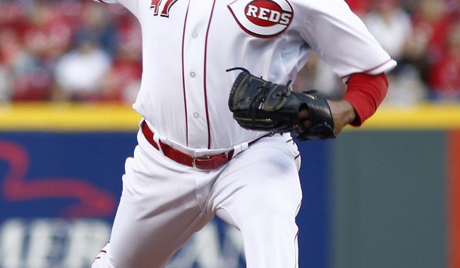 Cincinnati Reds starting pitcher Johnny Cueto throws against the Milwaukee Brewers during the first inning of a baseball game, Saturday, May 3, 2014, in Cincinnati. (AP Photo/David Kohl)