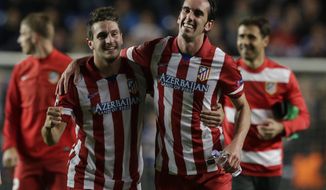 Atletico&#39;s Koke, left and teammate Atletico&#39;s Diego Godin celebrate in front of their fans after defeating Chelsea in the Champions League semifinal second leg soccer match between Chelsea and Atletico Madrid at Stamford Bridge stadium in London, Wednesday, April 30, 2014. (AP Photo/Matt Dunham)