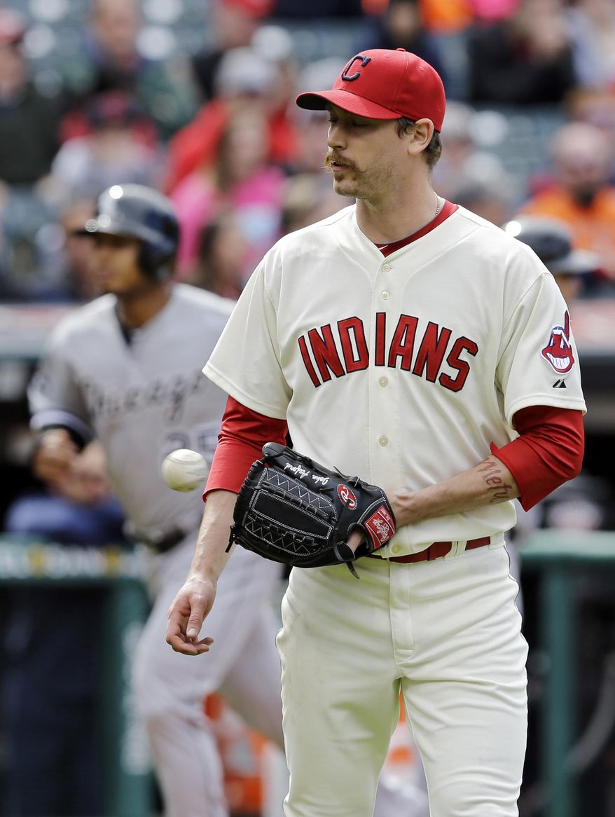Cleveland Indians relief pitcher John Axford gets a new ball after giving up a three-run home run to Chicago White Sox's Dayan Viciedo in the ninth inning of a baseball game Sunday, May 4, 2014, in Cleveland. Axford took the loss as Chicago won 4-3. (AP Photo/Mark Duncan)