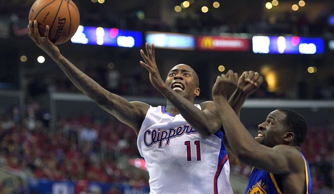 Los Angeles Clippers guard Jamal Crawford, left, goes up for a shot as Golden State Warriors forward Draymond Green defends during the first half in Game 7 of an opening-round NBA basketball playoff series, Saturday, May 3, 2014, in Los Angeles. (AP Photo/Mark J. Terrill)