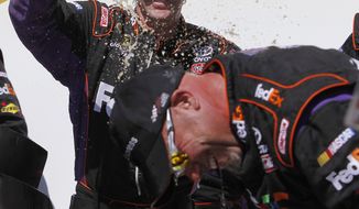 Denny Hamlin&#x27;s crew celebrates after the NASCAR Aaron&#x27;s 499 Sprint Cup series auto race at Talladega Superspeedway, Sunday, May 4, 2014, in Talladega, Ala. Hamlin won under caution. (AP Photo/Butch Dill)