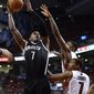Brooklyn Nets&#39; Joe Johnson, left, shoots over Toronto Raptors&#39; Kyle Lowry (7) and during the second half of Game 7 of the opening-round NBA basketball playoff series in Toronto, Sunday, May 4, 2014. (AP Photo/The Canadian Press, Frank Gunn)