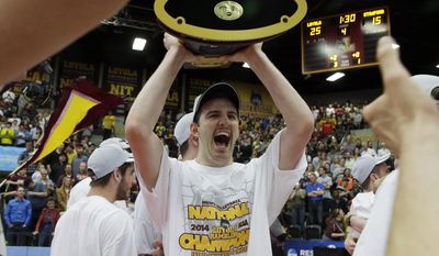 Loyola's Cody Caldwell (12), center, celebrates as he holds the championship trophy after his team defeated Stanford 3-1 in the NCAA men's college volleyball championship at Gentile Arena in Chicago on Saturday, May 3, 2014. (AP Photo/Nam Y. Huh)