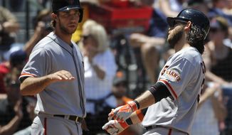 San Francisco Giants&#39; Brandon Crawford, right, is congratulated on his solo home run by teammate Madison Bumgarner during the fourth inning of a baseball game on Sunday, May 4, 2014, in Atlanta. (AP Photo/David Tulis)