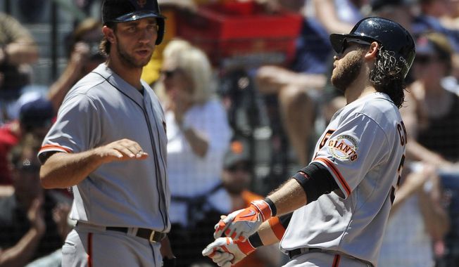 San Francisco Giants&#x27; Brandon Crawford, right, is congratulated on his solo home run by teammate Madison Bumgarner during the fourth inning of a baseball game on Sunday, May 4, 2014, in Atlanta. (AP Photo/David Tulis)