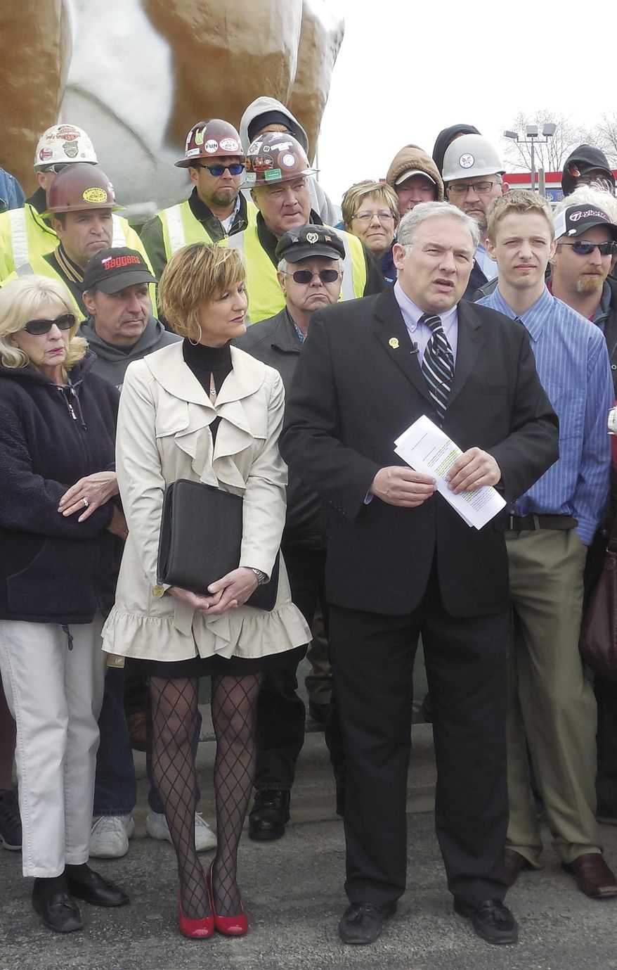 In this April 27, 2014 photo, Mike Sheridan, right, announces his candidacy for the Wisconsin State Senate in Janesville, Wis. Democrats and Republicans alike are pouring out of the woodwork in hopes of capturing one of more than two dozen open seats in the Legislature this fall, but it looks like they probably won't change the big picture _ Republicans probably will retain complete control of the statehouse, experts anticipate. (AP Photo/The Janesville Gazette, Neil Johnson)