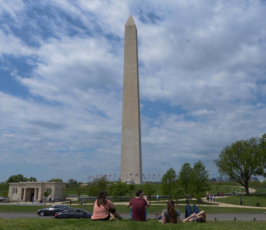 A group of students from Toronto take in the sights as they relax near the Washington Monument on Sunday. May 4. Khalid Naji-Allah Special to The Washington Times