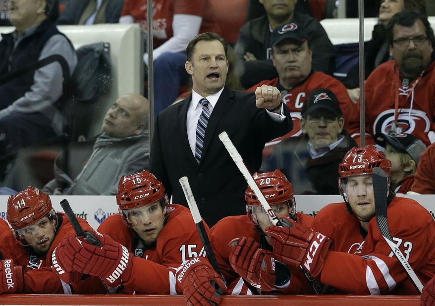 FILE - In this Jan. 31, 2014 file photo, Carolina Hurricanes coach Kirk Muller directs his team during the first period of an NHL hockey game against the St. Louis Blues in Raleigh, N.C. The Hurricanes have fired Muller. The team announced his dismissal Monday, May 5, 2014. (AP Photo/Gerry Broome, File)