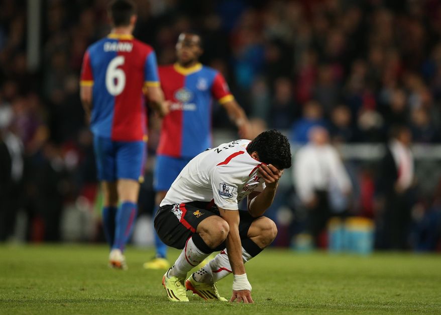 Liverpool's Luis Suarez, holds his shirt to his face following the end of the English Premier League soccer match between Crystal Palace and Liverpool at Selhurst Park stadium in London, Monday, May 5, 2014. The game ended in a 3-3 draw. (AP Photo/Alastair Grant)