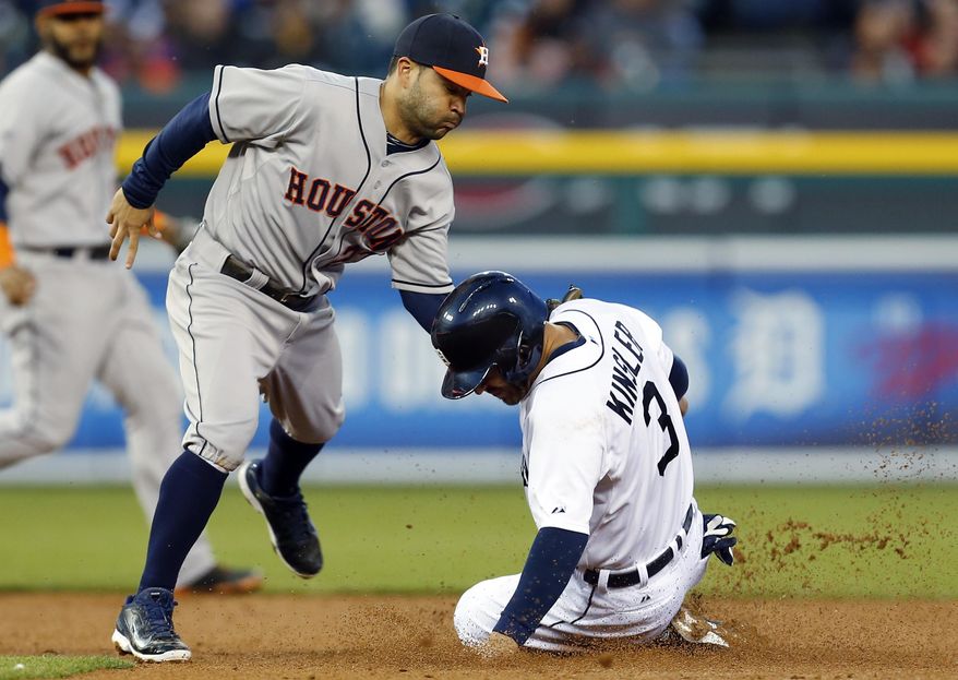 Detroit Tigers' Ian Kinsler (3) is tagged out by Houston Astros second baseman Jose Altuve (27) in the fifth inning of a baseball game in Detroit Monday, May 5, 2014. Kinsler was called safe but a challenge overturned the play. (AP Photo/Paul Sancya)