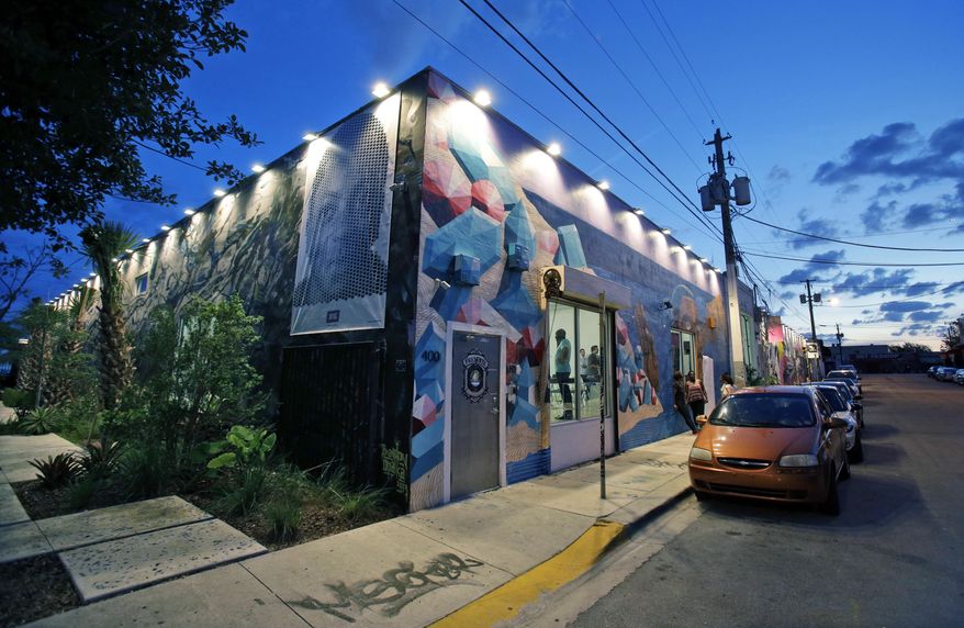 In this Thursday, April 10, 2014 photo, the sun sets behind The LAB Miami, a new tech focused collaborative space in the Wynwood Arts District in Miami. Famed for its beaches, cruises and cafecitos, South Florida is now angling to become one of the nation’s next tech hot spots by leveraging its role as the gateway to Latin America and luring northern entrepreneurs with cheap living costs and lots of sun. (AP Photo/Wilfredo Lee)
