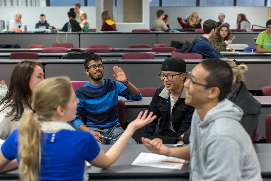Students in Professor Brad Hokanson's Creative Problem Solving class plan how they'll make Rube Goldberg machines Thursday, April 24, 2014 at the University of Minnesota. This class is also offered as a 7-week Massive Open Online Course, which includes video lectures and assignments to complete. The exercises are designed to encourage students to get out of their comfort zones and try new things. (AP Photo/Minnesota Public Radio, Jennifer Simonson)