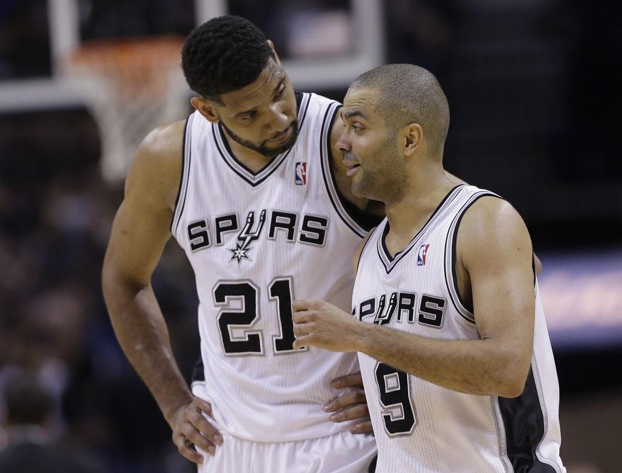San Antonio Spurs' Tim Duncan (21) and Tony Parker (9) walk of the court during the second half of Game 7 of the opening-round NBA basketball playoff series against the Dallas Mavericks, Sunday, May 4, 2014, in San Antonio. San Antonio won 119-96. (AP Photo/Eric Gay)