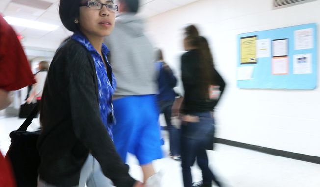Black River Falls High School sophomore Deanna Ramirez, 16, walks in school Friday, April 11, 2014. Ramirez is planning on attending college after she receives a traditional allocation of money made to Ho-Chunk Nation members after graduation from high school. (AP Photo/Wisconsin State Journal, John Hart)