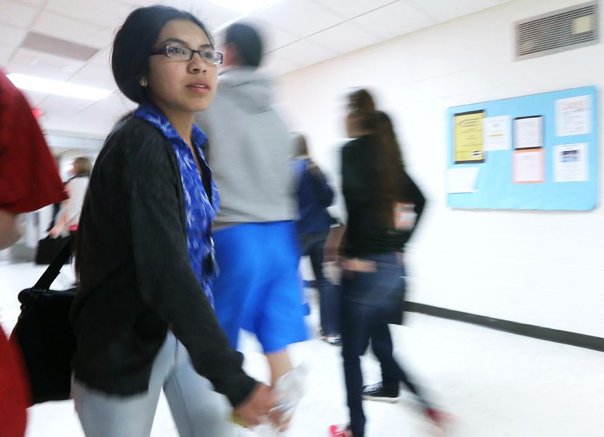 Black River Falls High School sophomore Deanna Ramirez, 16, walks in school Friday, April 11, 2014. Ramirez is planning on attending college after she receives a traditional allocation of money made to Ho-Chunk Nation members after graduation from high school. (AP Photo/Wisconsin State Journal, John Hart)