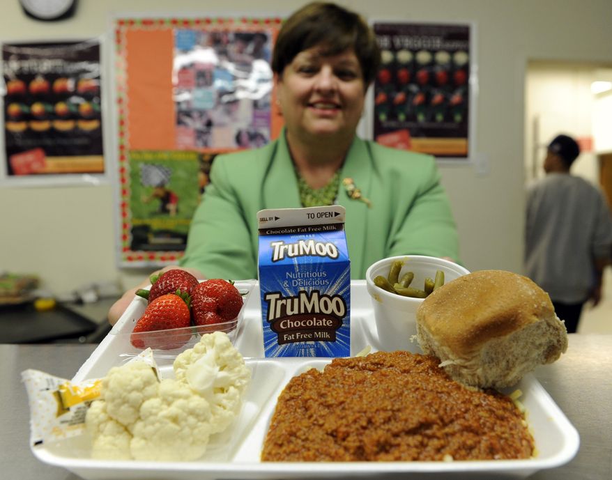 Becky Domokos-Bays, the Director of Food and Nutrition Services at Alexandria City Public Schools, holds up a tray of food during lunch service at the Patrick Henry Elementary School in Alexandria, Va., Tuesday, April 29, 2014. (AP Photo/Susan Walsh)